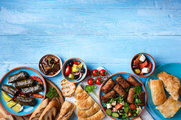 Traditional greek food on a blue wooden background.Copy space