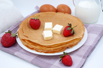 Pancakes with strawberries and ingredients for cooking