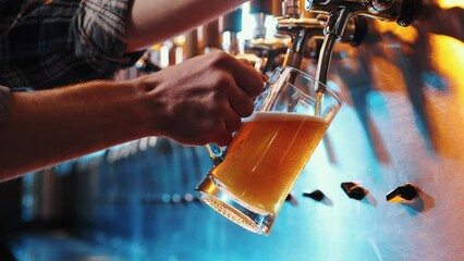Close-up pf male hand of bartender pouring a large glass of lager beer with tap. Pouring beer for client at pub, bar. Beer degustation. Concept of alcohol drink, party, taste, relaxation. Ad