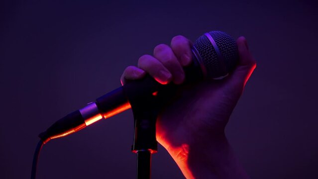 Shure sm58 microphone. Hold the microphone in your hand. Microphone stand.