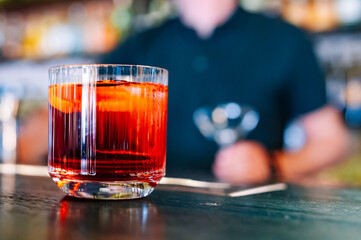 Cocktail Negroni with gin, campari martini rosso and orange. negroni cocktail in bar