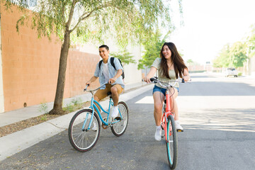 Cheerful couple enjoying going on a bike ride outdoors together