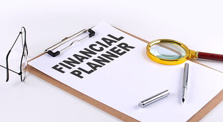 FINANCIAL PLANNER text on clipboard on white background, business concept
