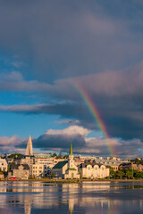 Historical and touristic downtown in Reykjavik at sunset and rainbow in Iceland. Cityscape at...