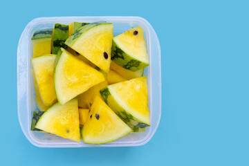 Yellow watermelon slices on blue background.