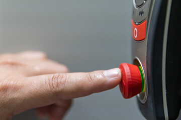 Emergency stop button. hand press emergency button of machine. Concept sefety first.