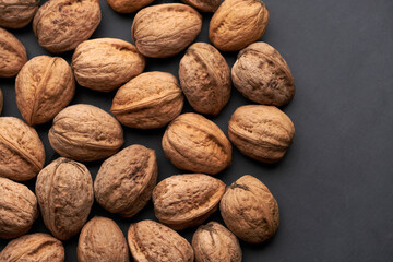 Whole walnuts nuts with shells close-up background studio shot