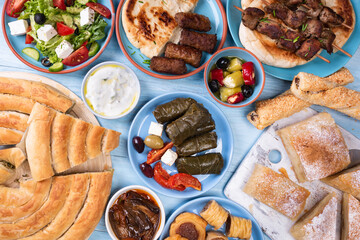  Traditional greek food on a blue wooden background.