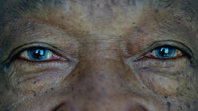 Senior African American macro close-up eyes and face looking at camera, an elderly black person with BLUE eyes