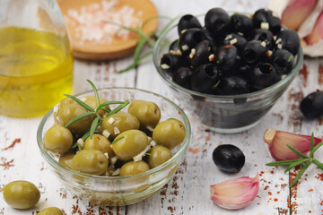 Black and green olives in glass bowls