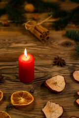 Fototapeta na wymiar Traditional Czech Christmas on wood decoration with twig, candle, apple, orange, fruit