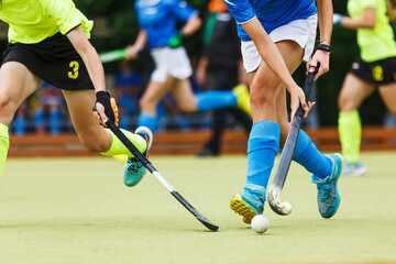 Close up image of attack in field hockey game.