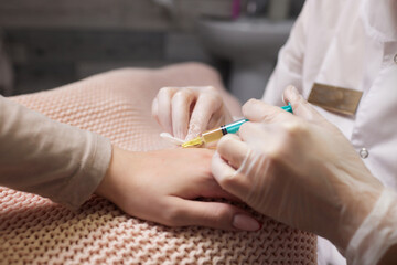 Doctor doing stem cell therapy on a patient's elbow after the injury. Treating knee pain with...