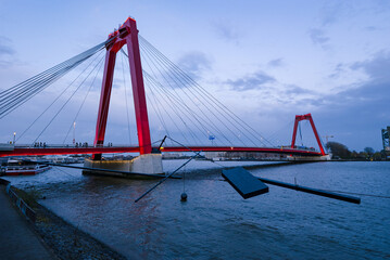 Red colored Willemsbrug over river Nieuwe Maas in Rotterdam, the Netherlands at blue hour night