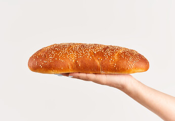 Homemade multigrain bread in woman hand over white background