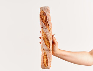 Baguette bread in woman hand over white background