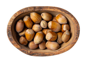 Hazelnuts in wooden bowl isolated on white.  Nuts in shell. Top view.
