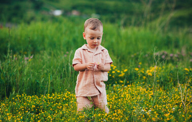 little baby playing in a field with wildflowers