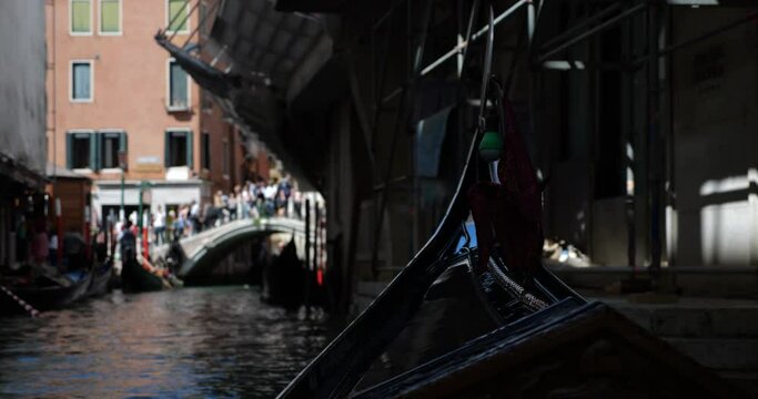 Gondolas with tourists waiting for disembarkation at the end of the tour through the canals of Venice, Italy. View on the Ponte San Mois&eacute;.