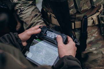 A group of Ukrainian military using tablet to operate the drone