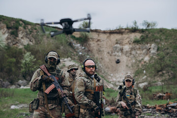 Fototapeta premium Ukrainian soldiers with a cyvilian drone looking in the camera