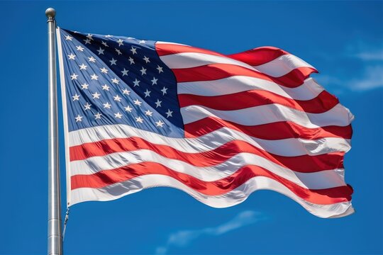 A powerful image of an American flag waving proudly in the wind against a clear blue sky. Generative AI