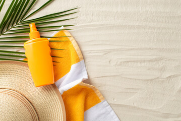 Sun protection on vacation concept. Top view photo of beach towel, straw hat, sunscreen spray and...
