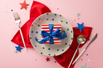 July 4th party menu. Top view perspective of table arrangement, dish, silverware, red serviette, star-shaped confetti, present box in USA flag wrapping, against pastel pink backdrop