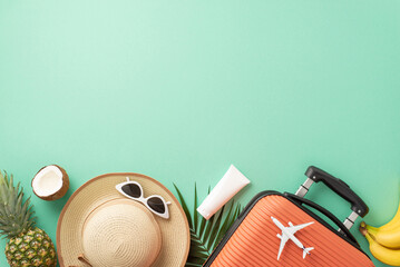 Summer vacation anticipation. Top view of suitcase, small plane replica, beach accessories,...