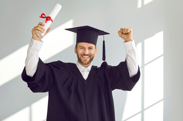 Yes, I did it. Excited college or university student having fun after graduation ceremony. Portrait...