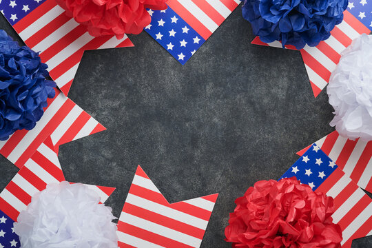 4th of July background. USA paper fans, Red, blue, white stars, balloons, gold confetti on gray dark concrete background. Happy Labor, Independence or Presidents Day. American flag colors. Top view.