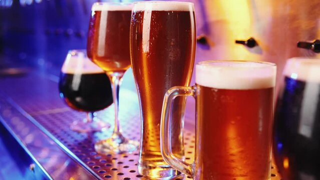 Close-up image of beer glasses with dark and lager beer. Selective focus. Cool, chill drink. Refreshment. Bar, pub atmosphere. Concept of alcohol drink, party, taste, relaxation. Ad