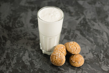 A delicious, refreshing summer drink, a milkshake made of milk and ice cream. Gingerbread on a dark table