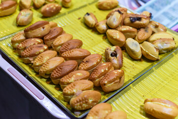 Vietnamese traditional corn cakes with chocolate sauce on a night market in food festival