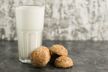 A delicious, refreshing summer drink, a milkshake made of milk and ice cream. Gingerbread on a dark table