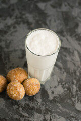 A delicious, refreshing summer drink, a milkshake made of milk and ice cream. Gingerbread on a dark table