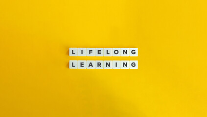 Lifelong Learning Term on Letter Tiles on Yellow Background. Minimal Aesthetic.