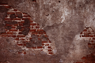 A weathered and textured brick wall in bad condition.