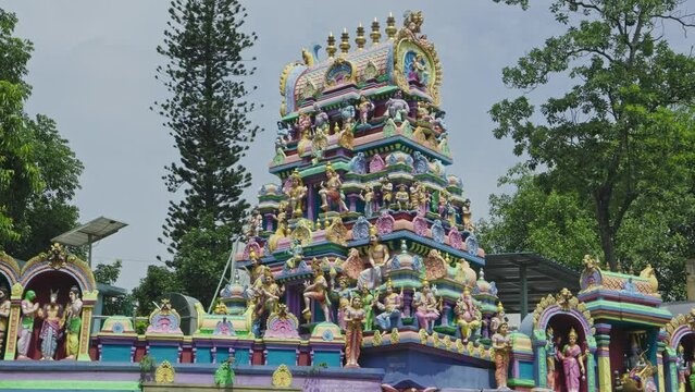 The Indian Hindu temple showcases a shikhara or tower adorned with god sculptures