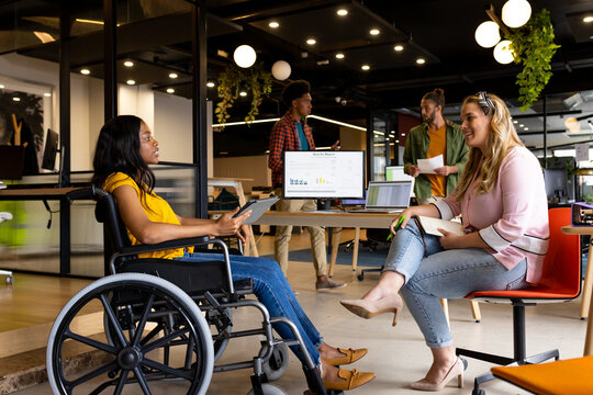 Diverse female colleagues in discussion at casual office meeting