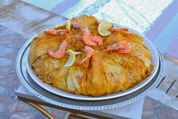 Moroccan pastilla or bastila with seafood, shrimp and calmari