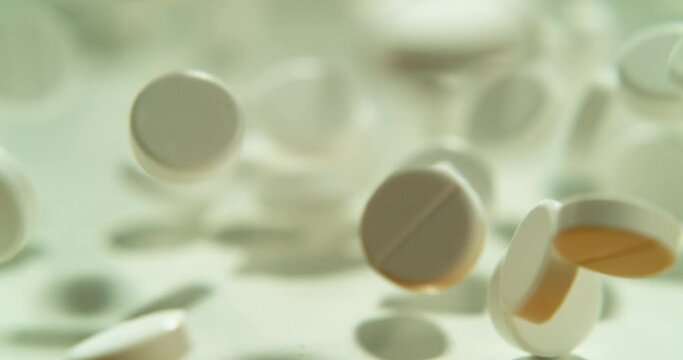 Drugs, pills fall and supplement medication in a studio with white background and capsule. Medicine, pharmacy product and prescription tablets for wellness and health with medical supplements spill