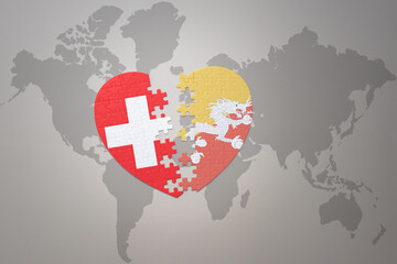 puzzle heart with the national flag of bhutan and switzerland on a world map background.Concept.