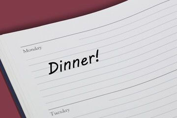 Dinner reminder note in black ink in a diary page