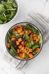  Green salad with sweet potatoes and sesame seeds. Vegan dish. Healthy eating. 