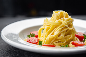 tagliatelle pasta tomato and parmesan cheese healthy meal food snack on the table copy space food background rustic top view veggie vegan or vegetarian food