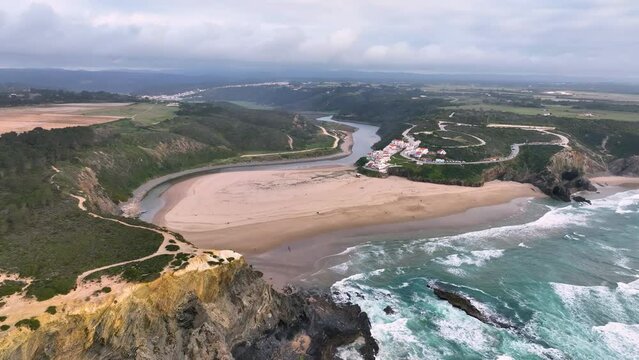 Aerial view of Praia de Odeceixe along Ribeira de Seixe river, Odeceixe, Faro, Portugal.
