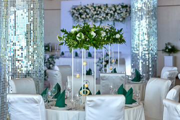 Festive banquet table with dishes and flowers on a white tablecloth