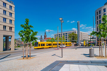 Dresden, Germany -  Famous modern yellow tram at Post Square with fountains. Cityscape of the...