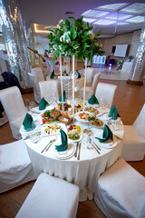 Festive buffet table with various dishes on a white tablecloth